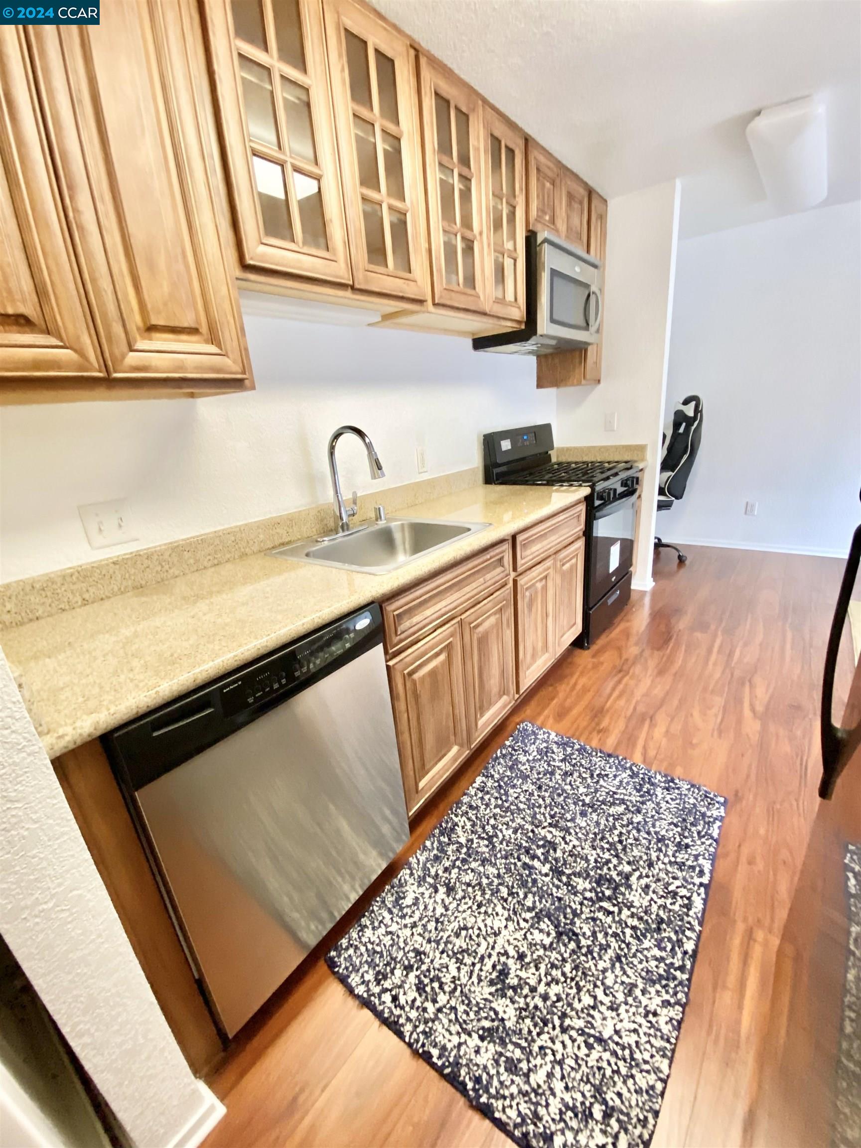 222 Piedmont Lane Pittsburg, CA 94565 - Photo 10 of 25 a kitchen with stainless steel appliances granite countertop a sink stove and cabinets