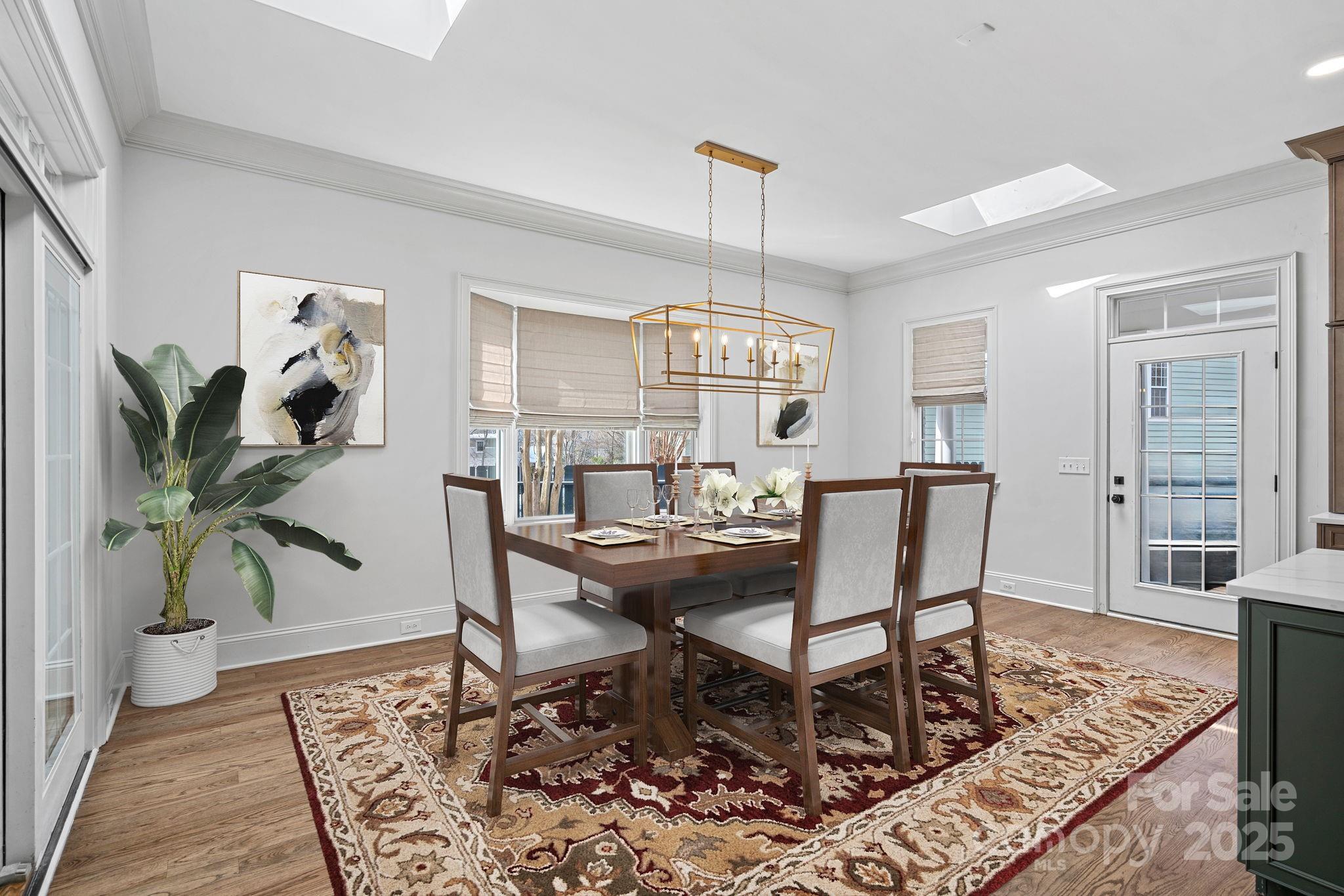 357 Magnolia Street Davidson, NC 28036 - Photo 16 of 48 a view of a dining room with furniture window and wooden floor