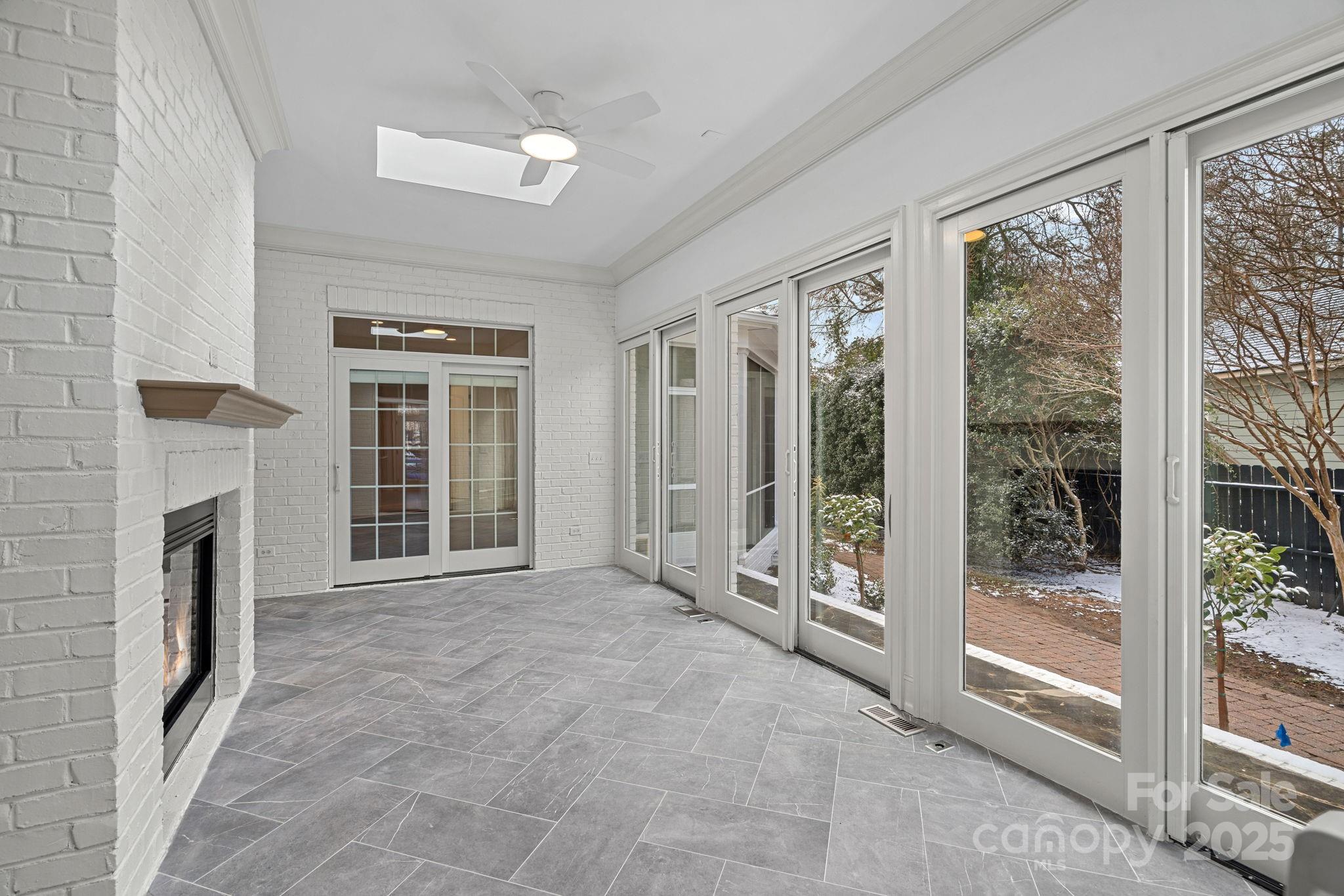357 Magnolia Street Davidson, NC 28036 - Photo 20 of 48 a view of an empty room with a fireplace and a window