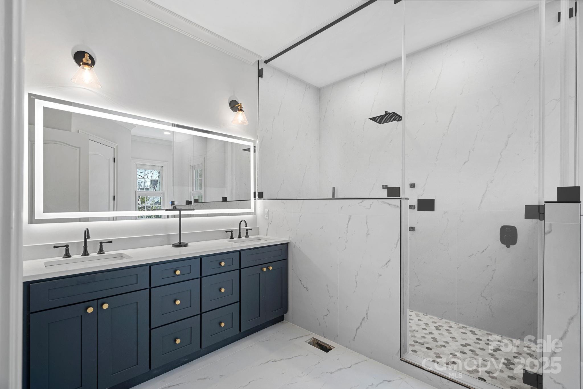 357 Magnolia Street Davidson, NC 28036 - Photo 25 of 48 a bathroom with a shower sink and mirror