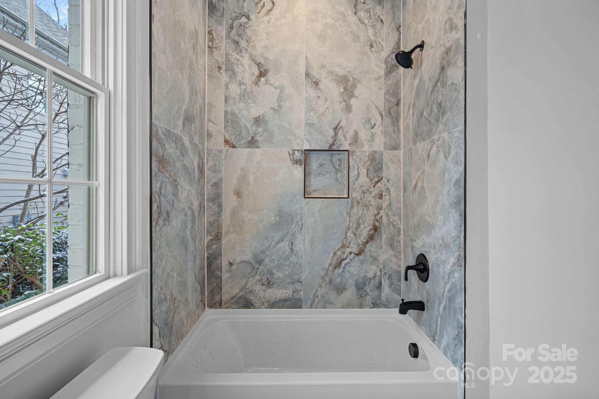 357 Magnolia Street Davidson, NC 28036 - Photo 31 of 48 a bathroom with a bath tub and a shower