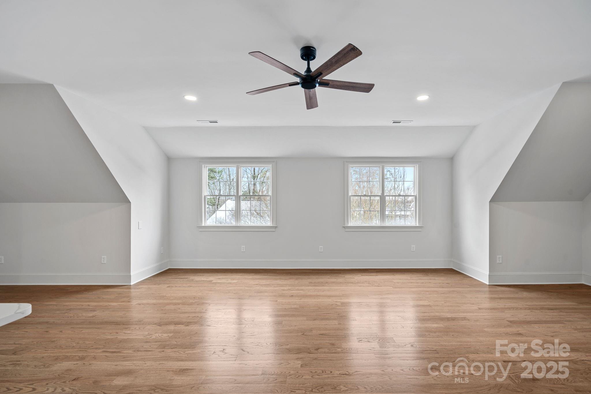 357 Magnolia Street Davidson, NC 28036 - Photo 35 of 48 a view of empty room with wooden floor and ceiling fan