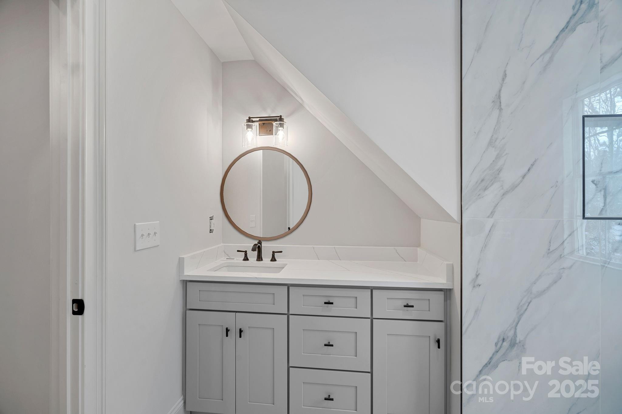 357 Magnolia Street Davidson, NC 28036 - Photo 36 of 48 a bathroom with a sink and a mirror