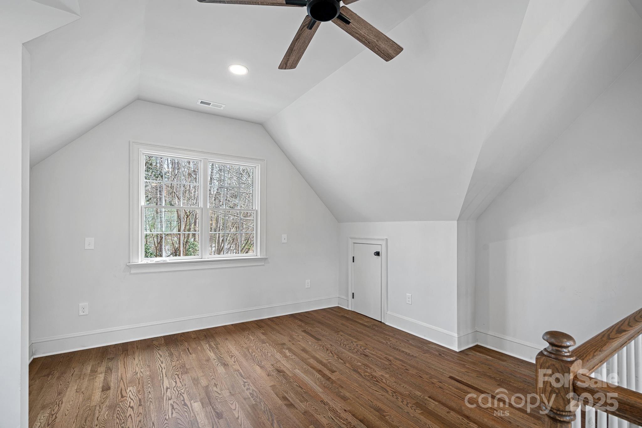 357 Magnolia Street Davidson, NC 28036 - Photo 46 of 48 a view of an empty room with wooden floor and a window