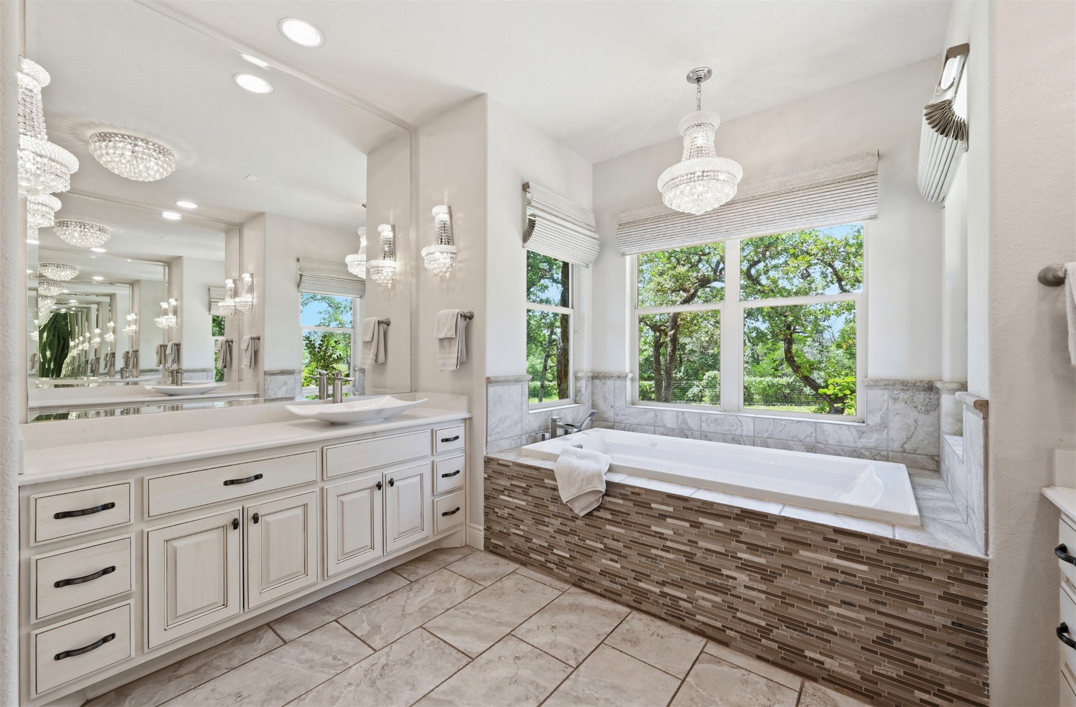 387 Corral Road Smithville, TX 78957 - Photo 19 of 40 Spacious bathroom featuring a built-in soaking tub with a mosaic tile surround and a large window
