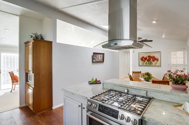 a kitchen with stainless steel appliances granite countertop a stove and a refrigerator