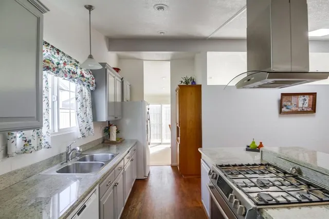 a kitchen with a sink stove and refrigerator