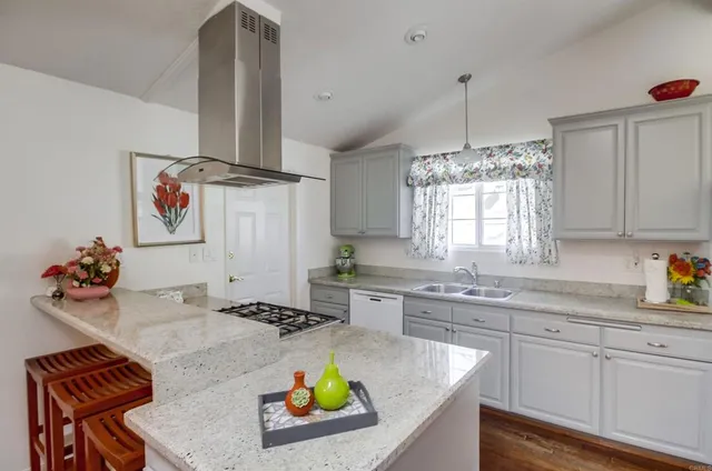 a kitchen with stainless steel appliances granite countertop a sink and cabinets