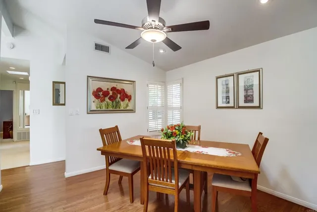 a view of a dining room with furniture wooden floor and a chandelier