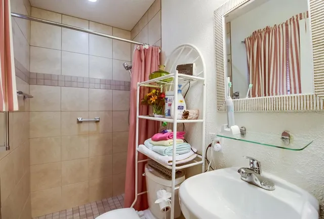 a bathroom with a sink toilet and shower