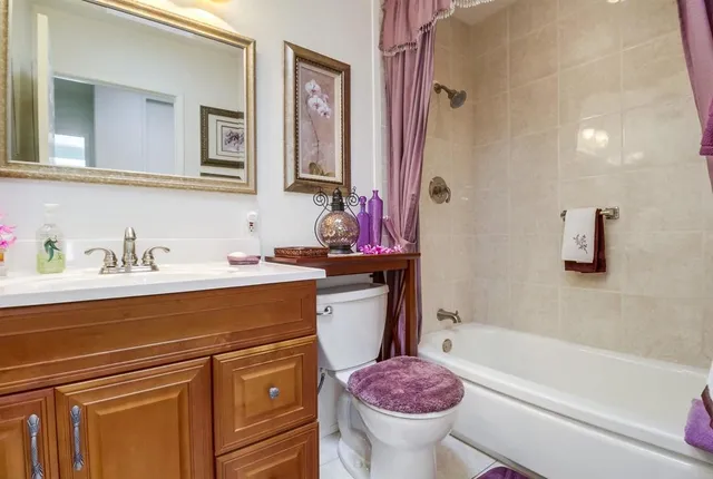a bathroom with a sink toilet vanity and bathtub