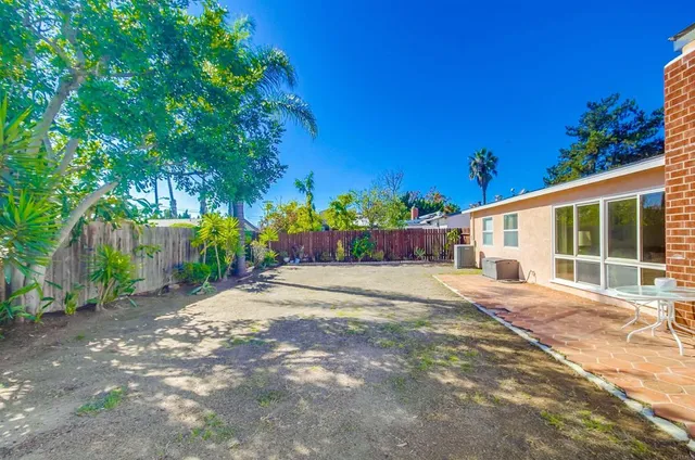 a front view of a house with a yard and potted plants