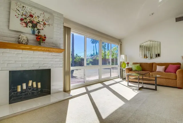 a living room with furniture and a fireplace