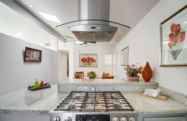 a room with painting on the wall and a rug