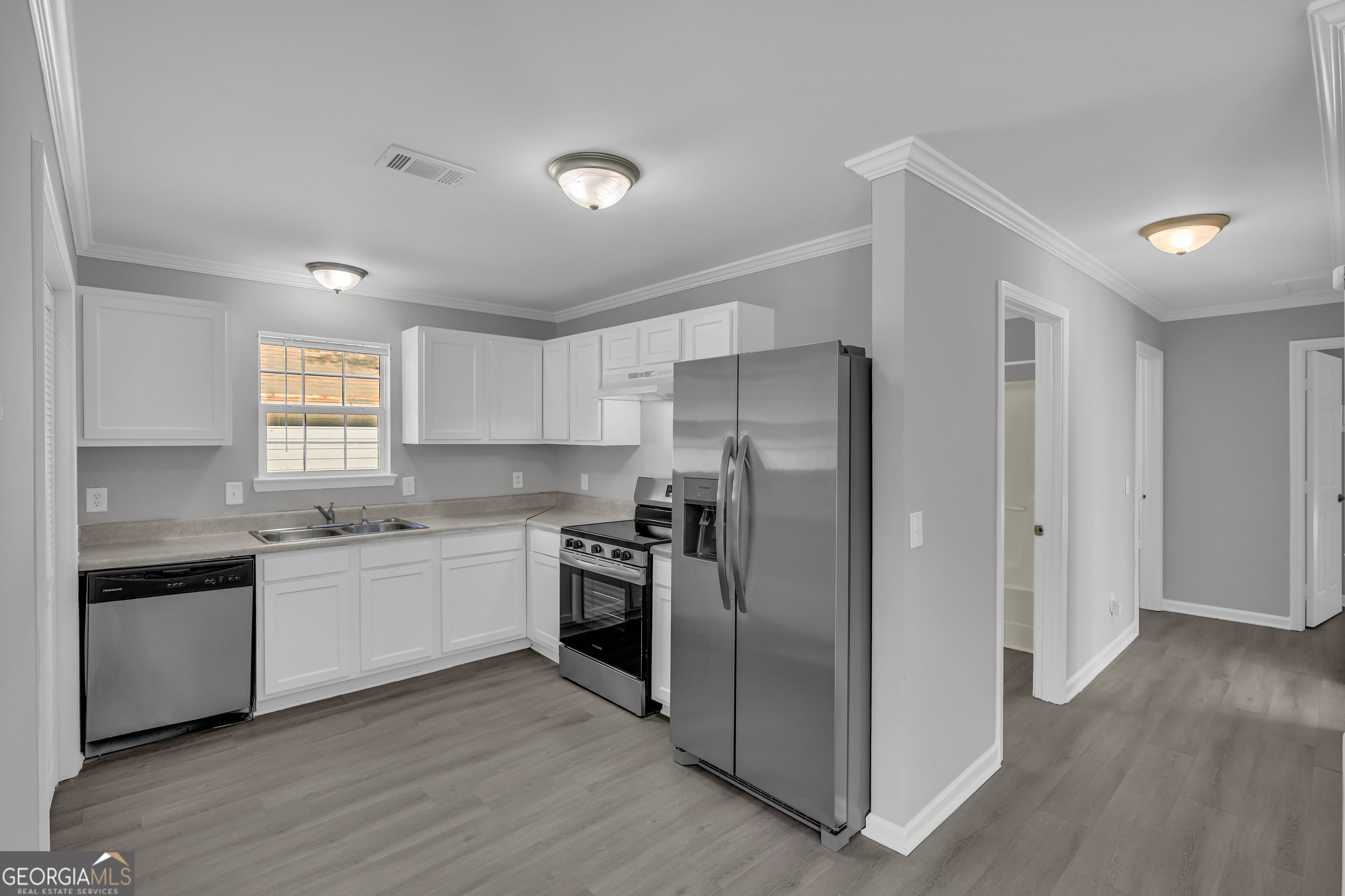 1040 Thomasville Estates Drive Southeast Atlanta, GA 30315 - Photo 11 of 57 a kitchen with stainless steel appliances granite countertop a refrigerator and a stove top oven