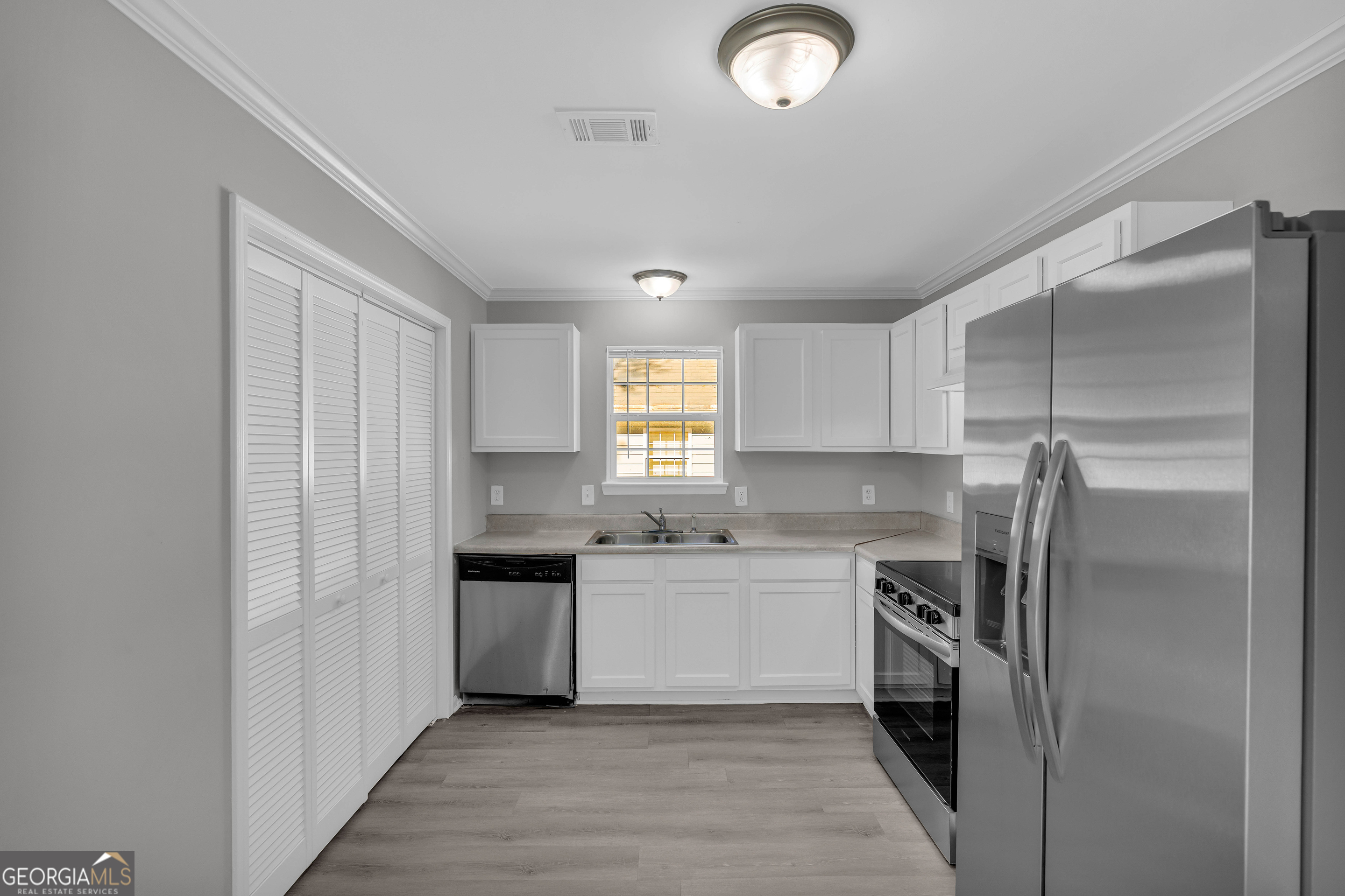 1040 Thomasville Estates Drive Southeast Atlanta, GA 30315 - Photo 14 of 57 a kitchen with a sink and stainless steel appliances