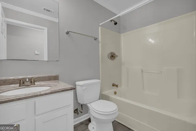 an empty room with wooden floor and closet