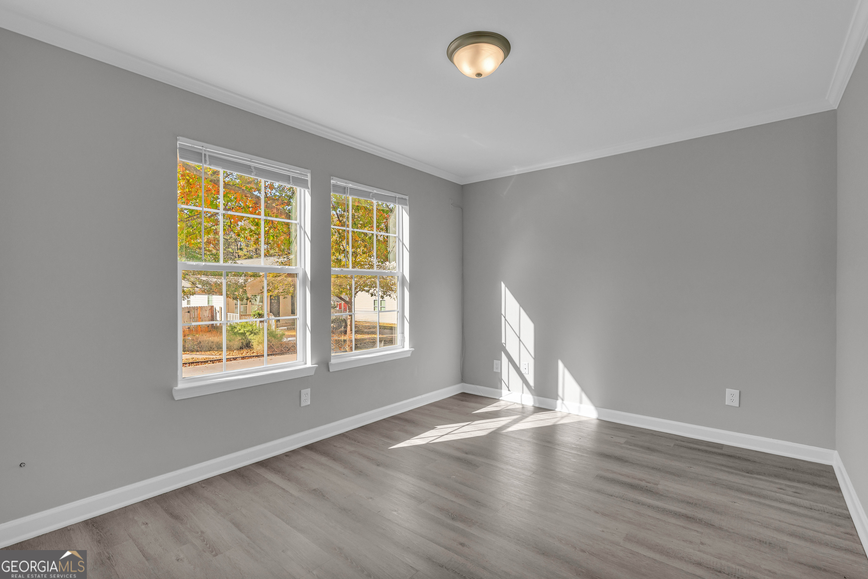 1040 Thomasville Estates Drive Southeast Atlanta, GA 30315 - Photo 20 of 57 an empty room with wooden floor and windows