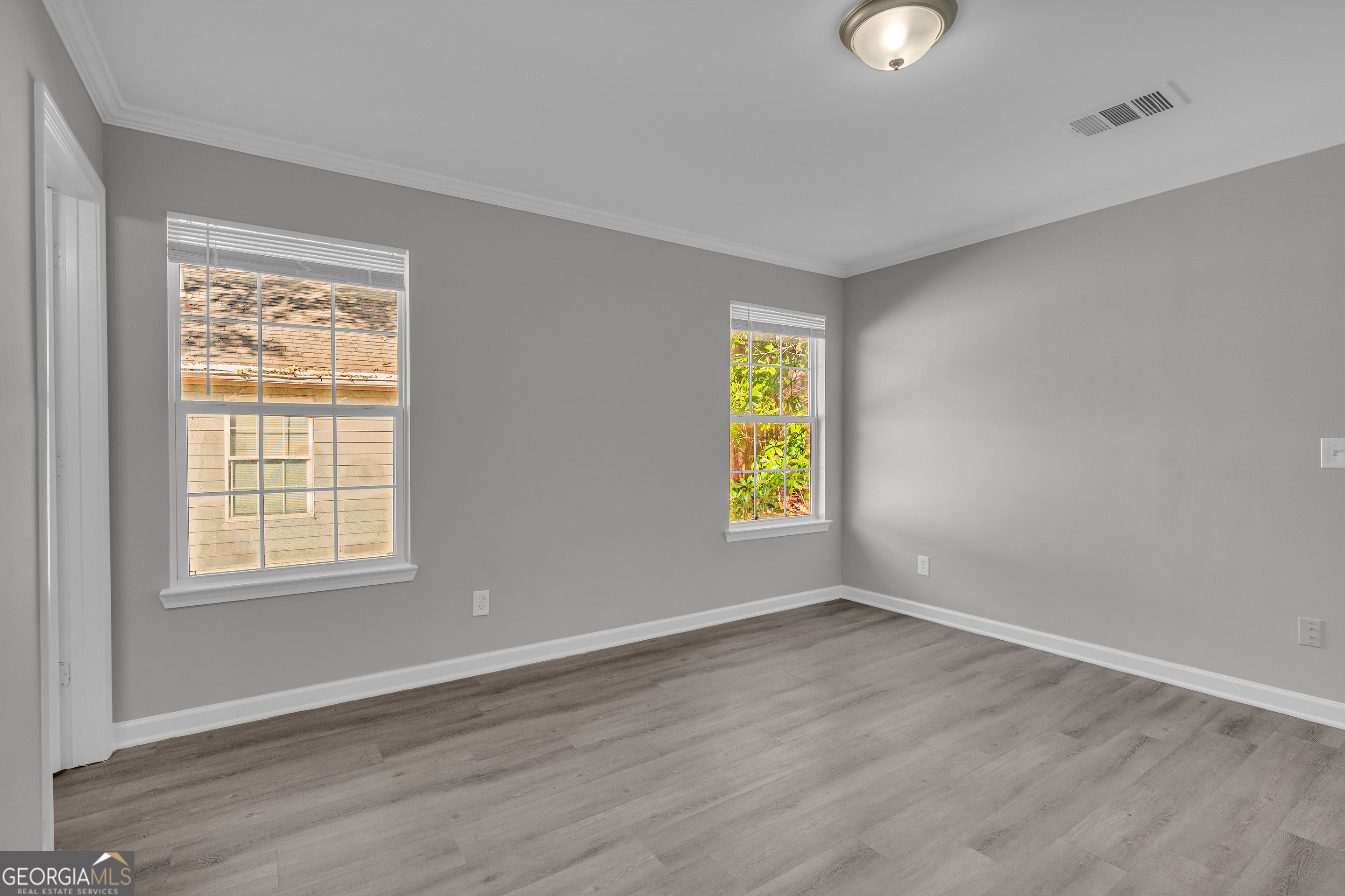 1040 Thomasville Estates Drive Southeast Atlanta, GA 30315 - Photo 22 of 57 an empty room with a window and wooden floor