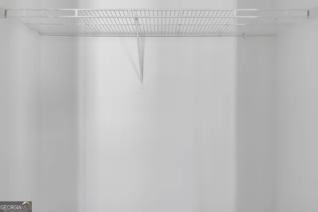 a picture of a bench in front of a wall