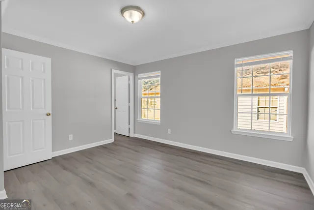 a view of an empty room with wooden floor