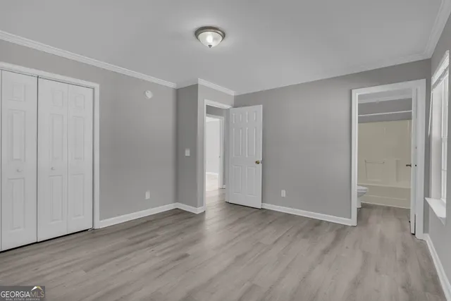 a view of an empty room with wooden floor