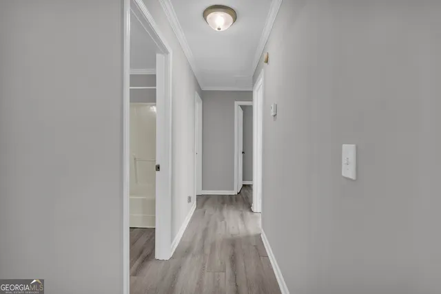 a view of an empty room with wooden floor