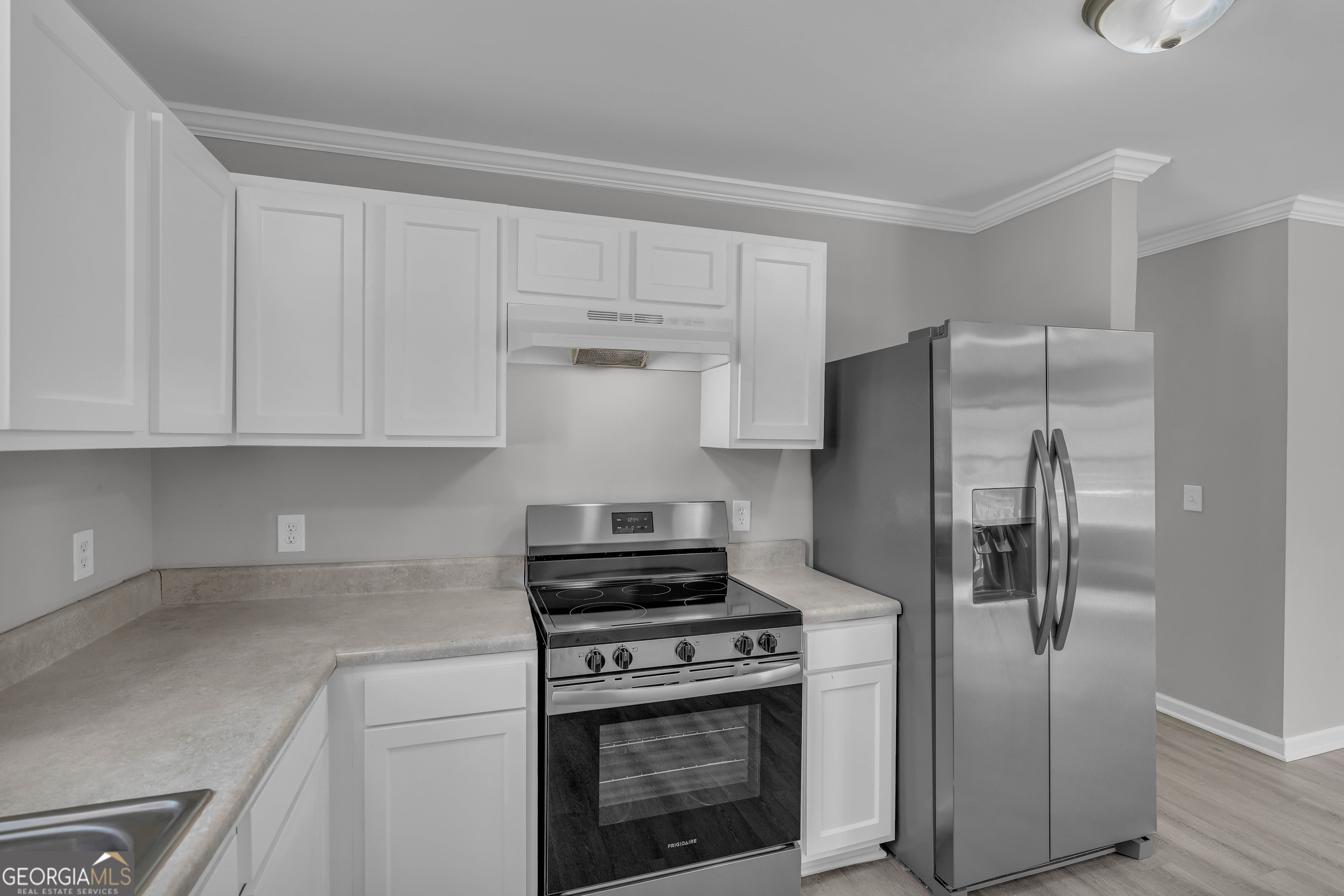 1040 Thomasville Estates Drive Southeast Atlanta, GA 30315 - Photo 33 of 57 a kitchen with cabinets and stainless steel appliances