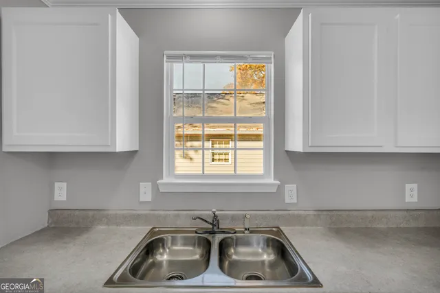 a view of a yard with plants and trees