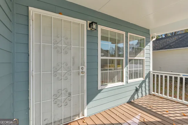 a view of a house with wooden fence