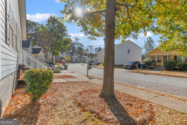 a front view of a house with a yard covered in snow