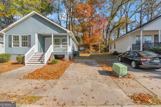 a front view of a house with a yard covered in snow