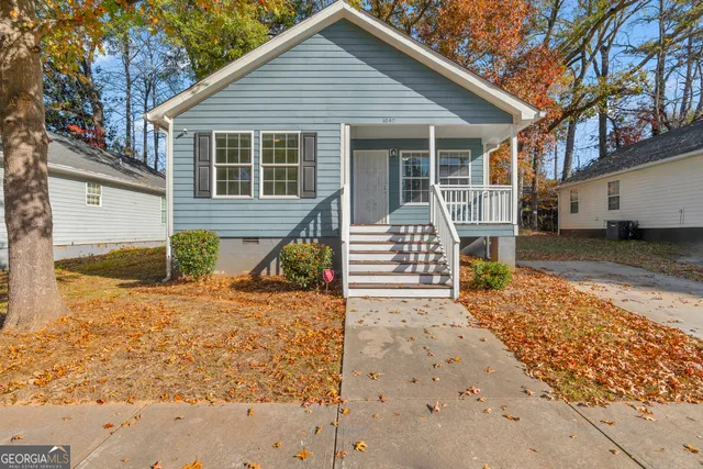 a view of a house with snow on the road
