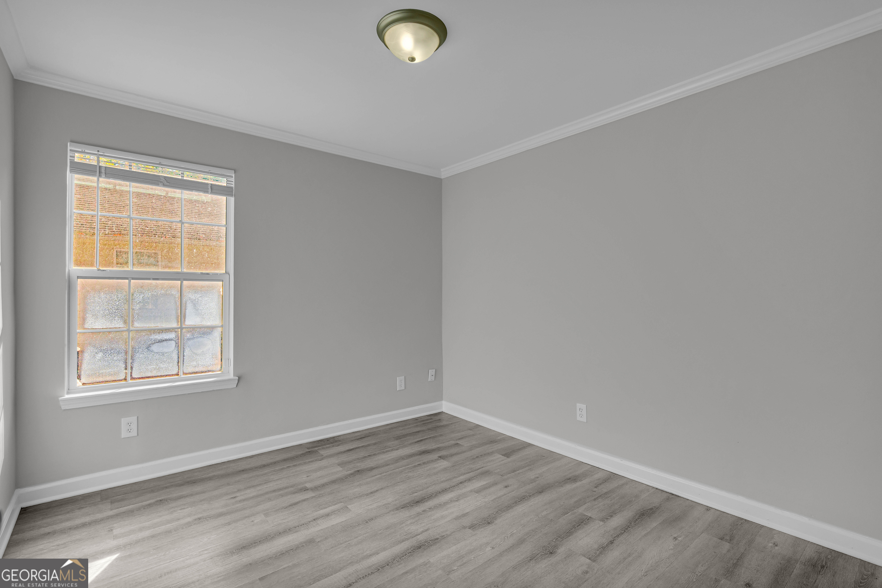 1040 Thomasville Estates Drive Southeast Atlanta, GA 30315 - Photo 57 of 57 an empty room with wooden floor and windows