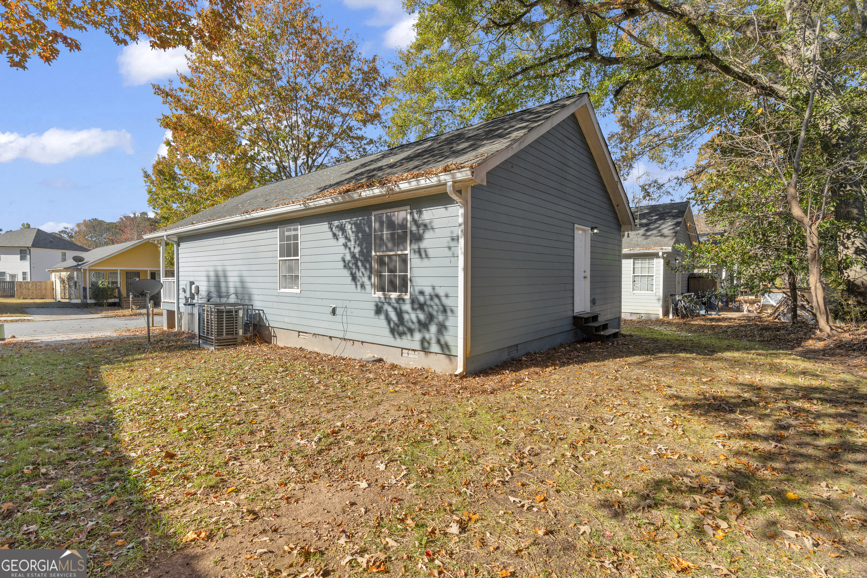 1040 Thomasville Estates Drive Southeast Atlanta, GA 30315 - Photo 7 of 57 a backyard of a house with large trees and table and chairs