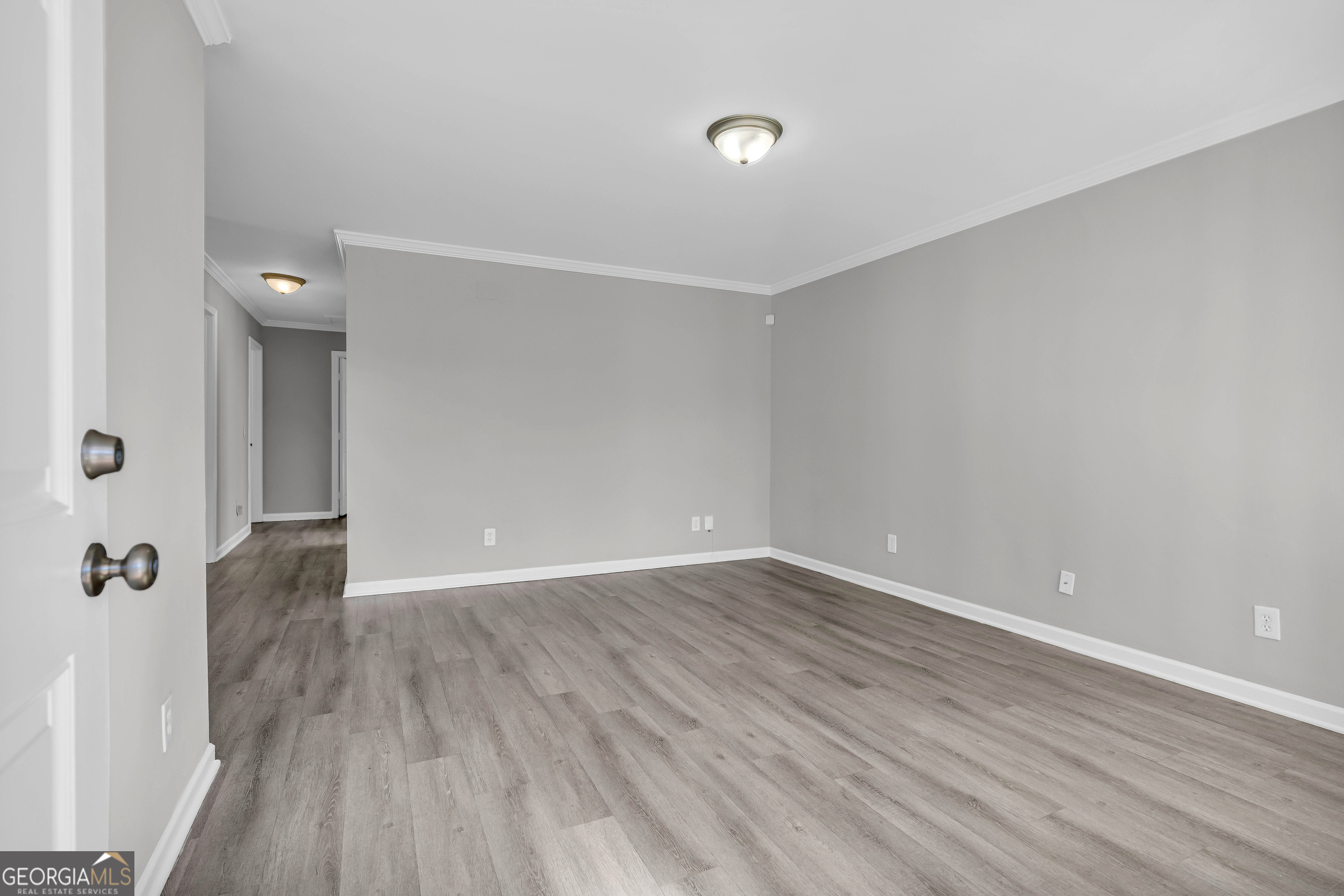 1040 Thomasville Estates Drive Southeast Atlanta, GA 30315 - Photo 8 of 57 a view of an empty room with wooden floor and a window
