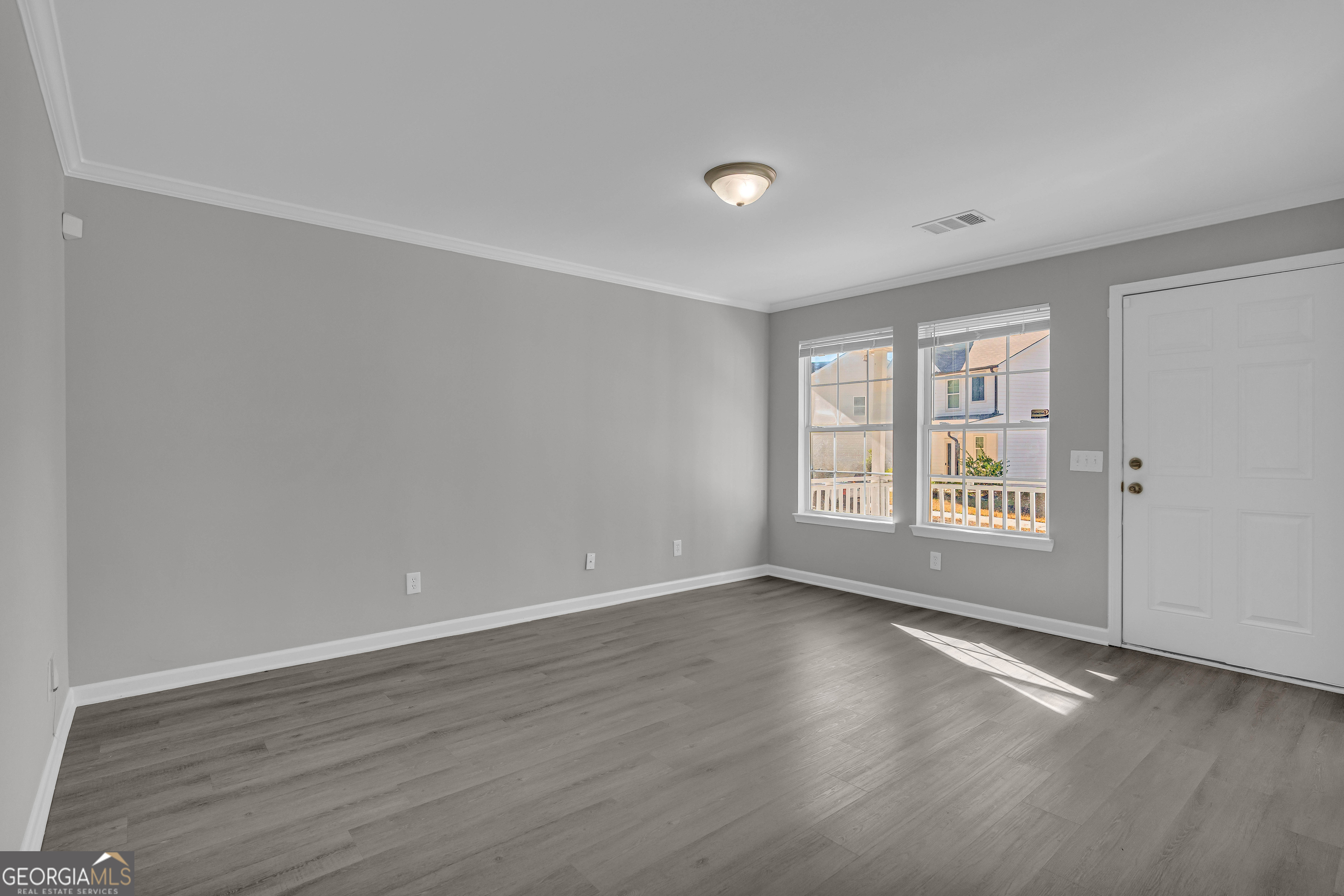 1040 Thomasville Estates Drive Southeast Atlanta, GA 30315 - Photo 10 of 57 a view of an empty room with wooden floor and a window