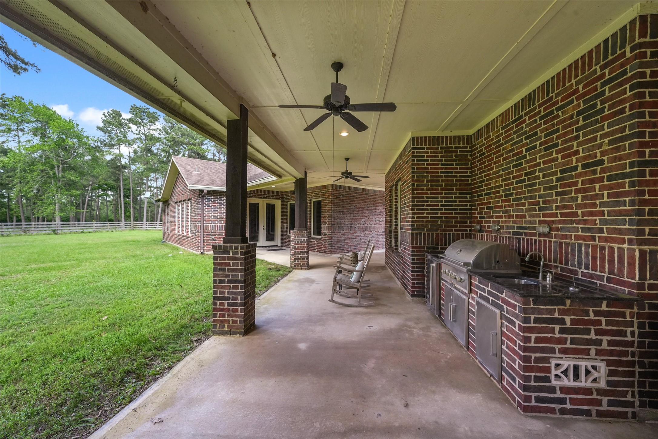 26250 A Riley Road Waller, TX 77484 - Photo 25 of 50 Extended covered patio with ceiling fans and grill station; generous space to relax or dine al fresco.