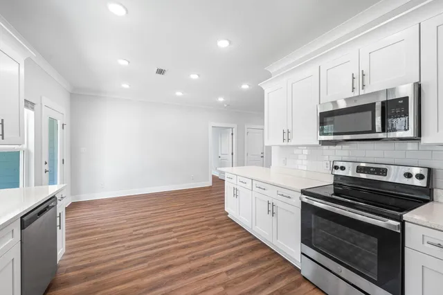 a kitchen with a sink and large window