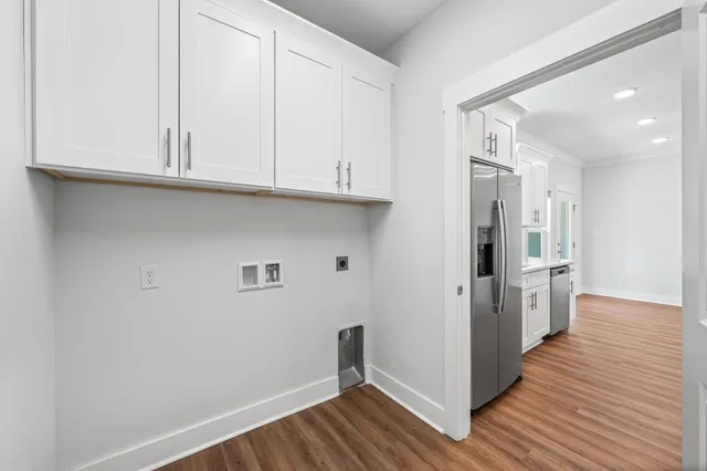 an empty room with wooden floor and window