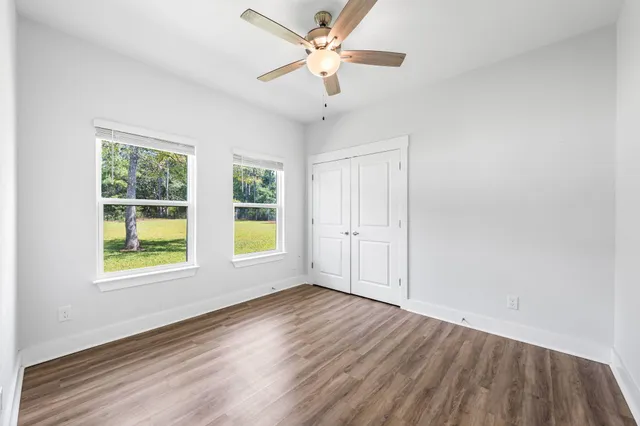wooden floor in an empty room with a window