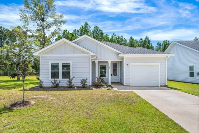 a view of empty room with wooden floor and window