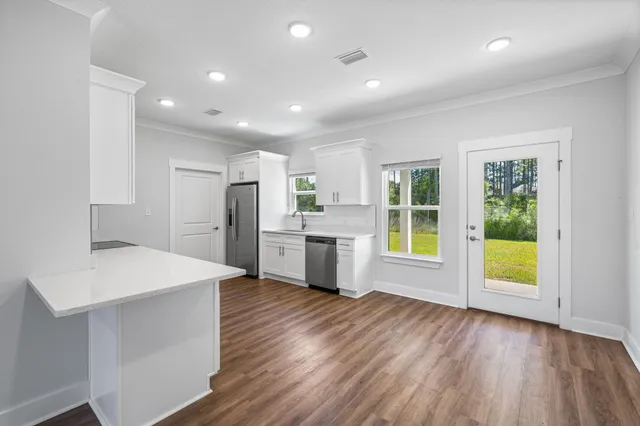 a view of kitchen with sink and wooden floor