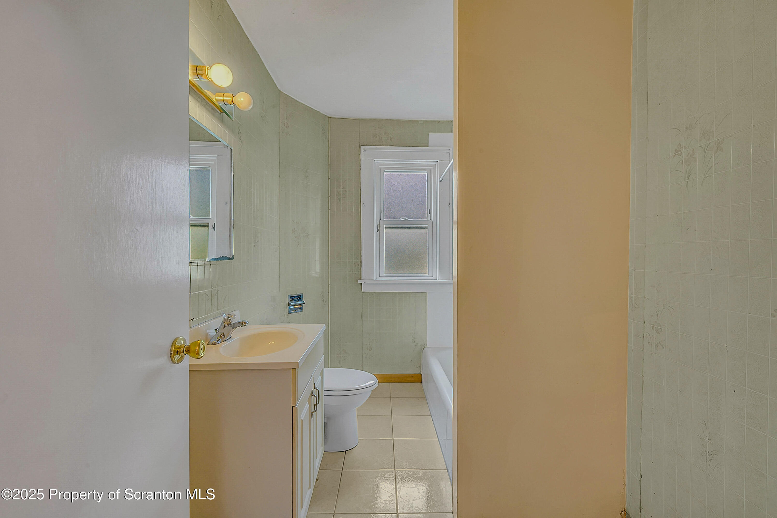 2819 Birney Avenue Scranton, PA 18505 - Photo 13 of 20 a bathroom with a toilet sink and mirror