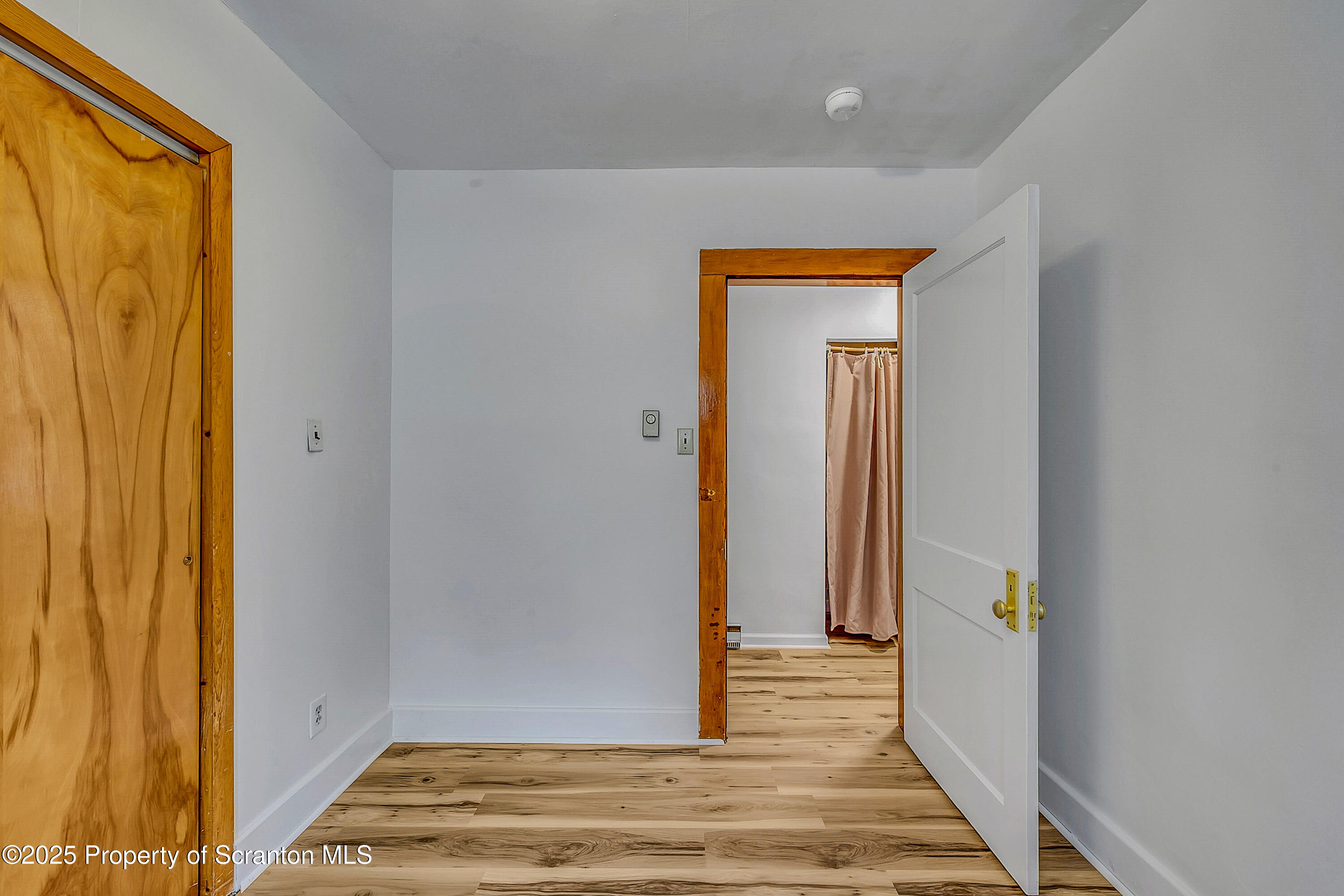 2819 Birney Avenue Scranton, PA 18505 - Photo 16 of 20 a view of a hallway with wooden floor and a bathroom