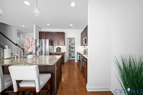 a dining room with furniture and wooden floor