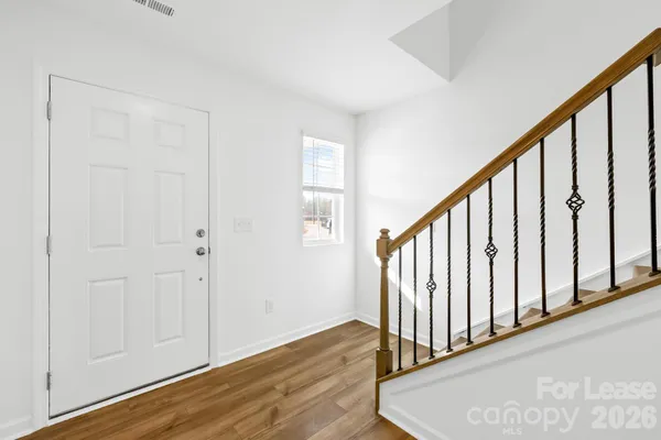 a view of staircase with white walls and a window