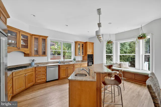 a view of a kitchen with granite countertop a stove and a sink