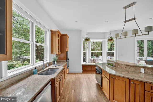 a kitchen with granite countertop a sink a counter top space and living room