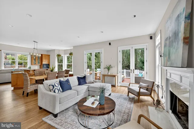 a living room with fireplace furniture and a large window